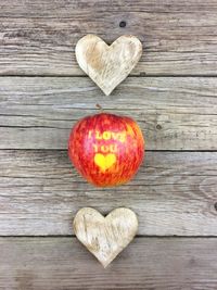 Close-up of heart shape with apple on table