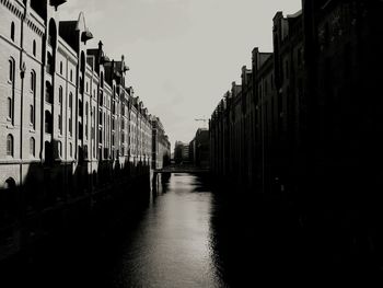 River amidst buildings against sky