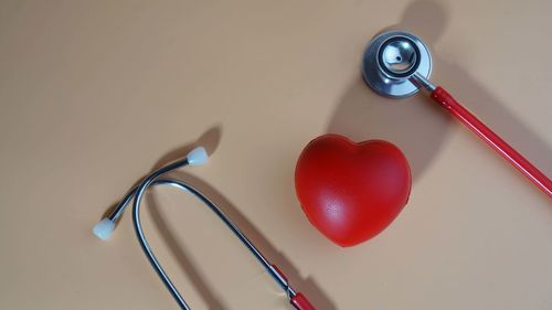 High angle view of heart shape on table against wall