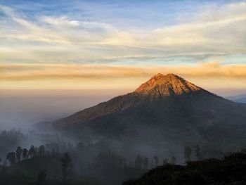 Scenic view of mountains against sky at sunset