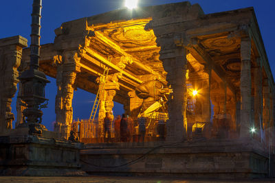 Low angle view of illuminated temple building against sky