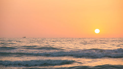 Scenic view of sea against orange sky