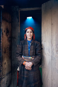 Portrait of man standing against wall