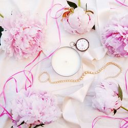 Peony flowers with candle and ladies pocket watch