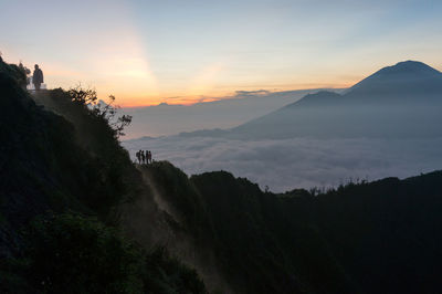 Scenic view of landscape against cloudy sky