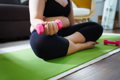 Low section of woman exercising in gym