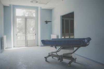 Empty chairs and table in building