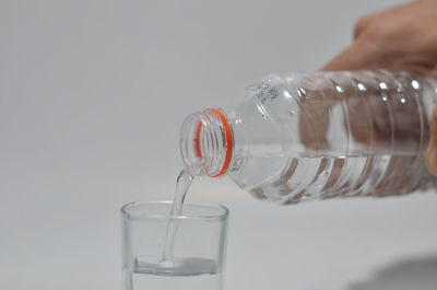 Close-up of hand pouring water in glass