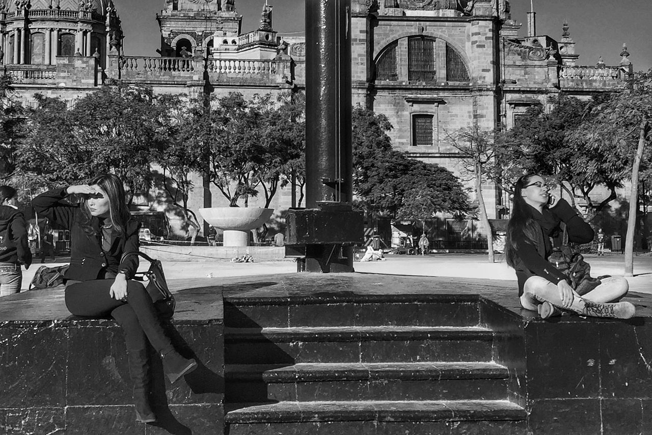 building exterior, men, architecture, built structure, lifestyles, person, leisure activity, street, city, steps, bicycle, full length, walking, tree, incidental people, land vehicle, medium group of people, outdoors, day