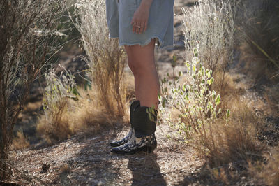 Low section of woman standing on land