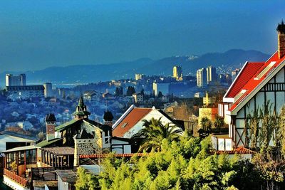 High angle view of buildings against blue sky