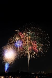 Low angle view of firework display at night