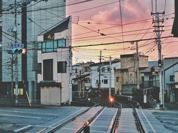 Railroad tracks by buildings in city japan sky