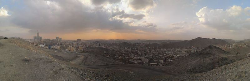 Panoramic view of cityscape against cloudy sky