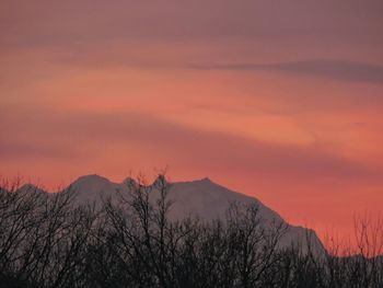 Scenic view of mountains against sky at sunset