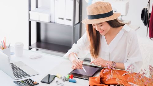 Midsection of woman using smart phone on table