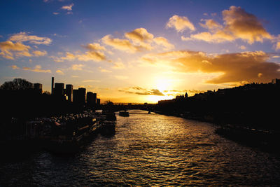 Scenic view of river against sky during sunset