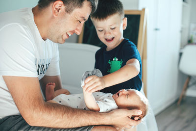 Father playing with children at home