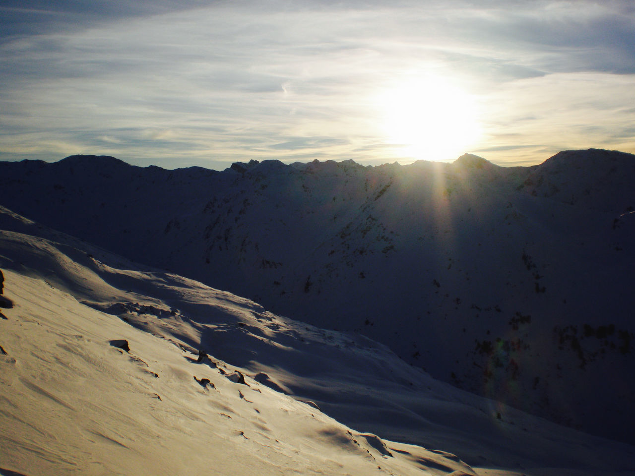 SCENIC VIEW OF SNOWCAPPED MOUNTAINS AGAINST BRIGHT SUN