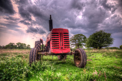 Abandoned truck on field against sky