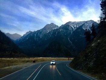 Road amidst mountains against sky