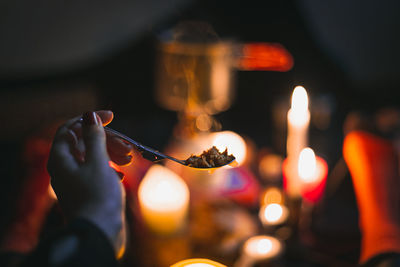 Close up female hand holding folding camping spoon with food concept photo