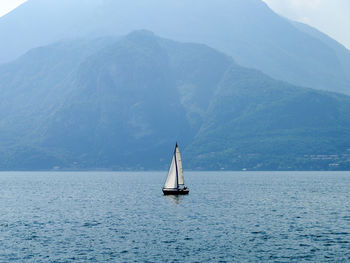 Sailboat sailing on sea against sky