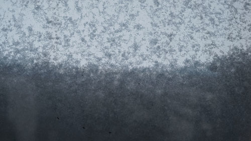 Full frame shot of snow covered metal during winter