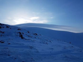 Scenic view of snow covered mountains against sky