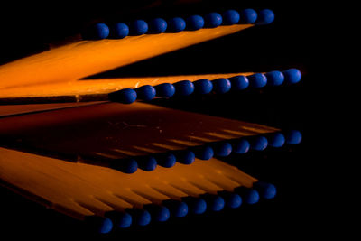 Close-up of multi colored pencils over black background