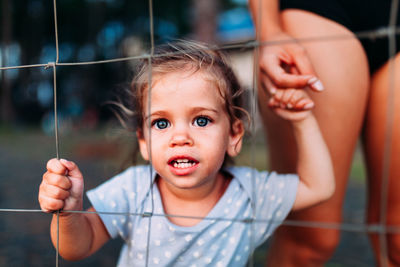 Portrait of cute girl holding baby