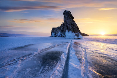 Scenic view of frozen sea against sky during sunset