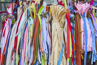 Multi colored ribbons hanging at market stall