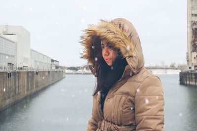 Full length of shirtless man in water against sky