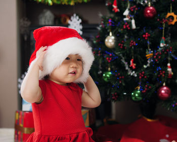 Portrait of cute baby girl in christmas tree