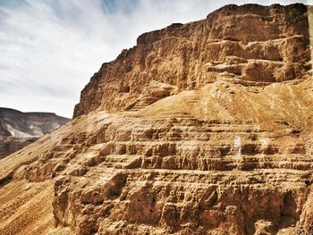 Low angle view of rock formation against sky