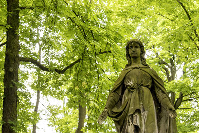 Low angle view of statue against trees