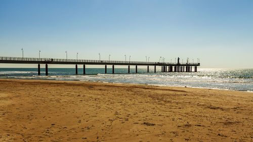 Pier over sea against clear sky