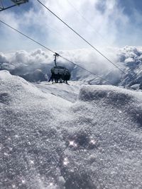 Snow covered land and mountains against sky