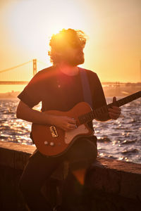 Street musician playing electric guitar in the street