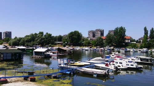 Boats in river with buildings in background