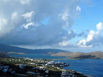 Aerial view of sea against cloudy sky