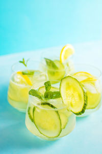 Summer refreshing cocktails with cucumber and lemon slices garnished with mint leaves. 