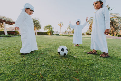 Low angle view of cute boys playing at park