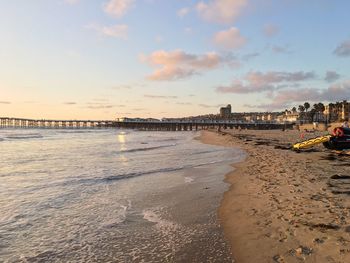 Scenic view of beach against sky during sunset