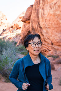 Portrait of senior asian woman hiking in the desert landscape