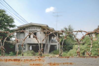 Metal fence against sky