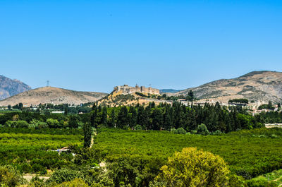 Scenic view of mountains against clear blue sky