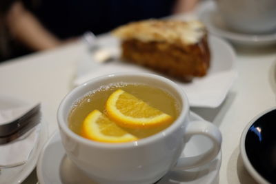 High angle view of tea cup with cake on table