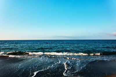 Scenic view of sea against clear blue sky